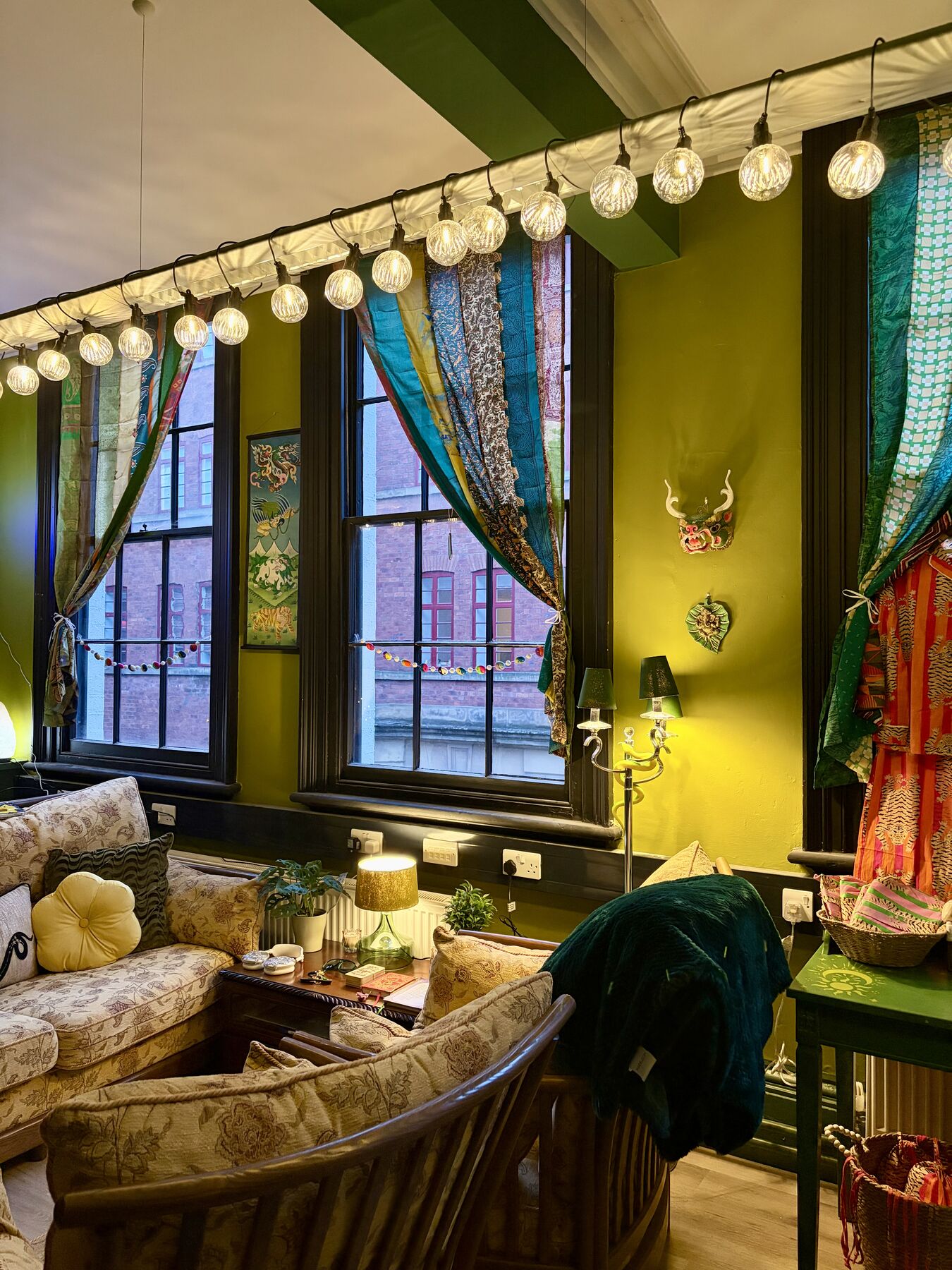 Cosy boutique corner at Green Light Sanctuary with cushions, textiles and string lights